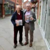 The creators of the book together in arms - holding copies of the book.